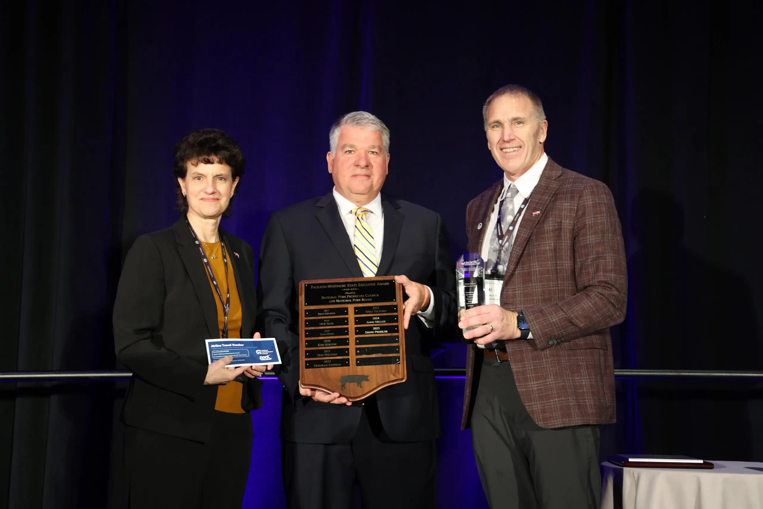 NPPC 2024-2025 President Lori Stevermer and National Pork Board President Al Wulfekuhle presented Dave Preisler (center) with the Paulson-Whitmore State Executive Award.