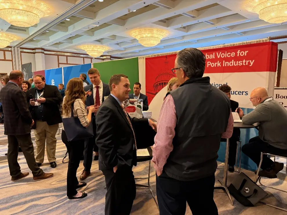 Texas Pork Producers Association Executive Director Colby Ferguson (center) speaks with NAFB attendees.