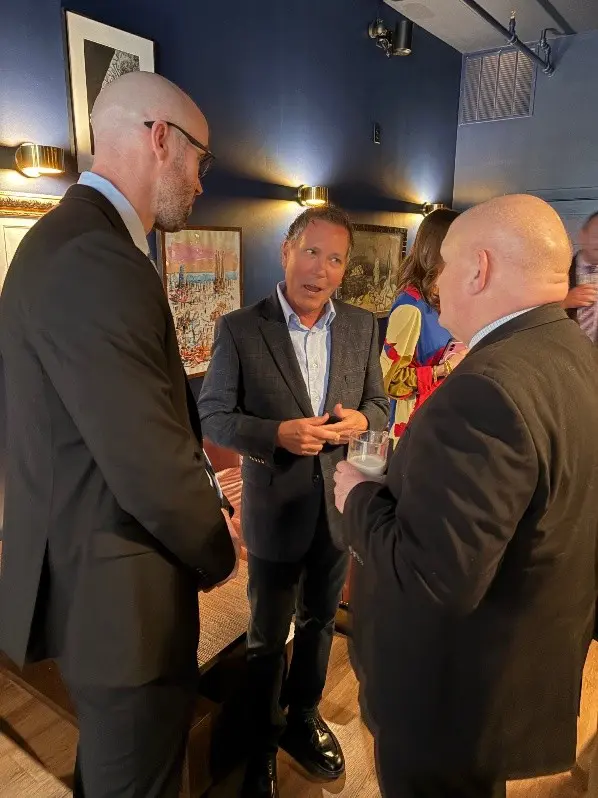 Left to right: Illinois pork producers Thomas Titus and Ken Maschhoff talk with Chairman Thompson.