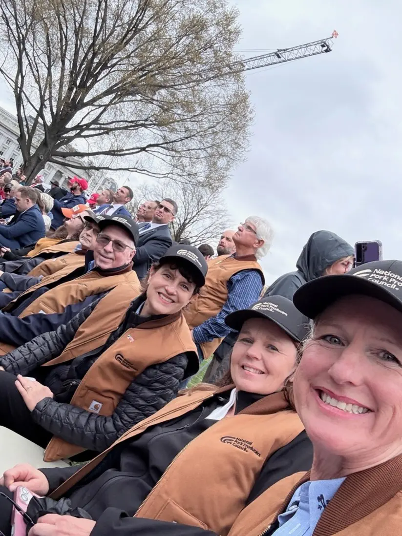 Pork producers celebrate agriculture at the White House. Left to right, in vests: Nebraska pork producer Leo Hanson, NPPC Immediate Past President and Ohio pork producer Duane Stateler, NPPC Past President and Minnesota pork producer Lori Stevermer, Iowa pork producer Trish Cook, and Indiana pork producer Jackie Bowman Ponder. Back row, in vest, is Missouri pork producer Bob North.