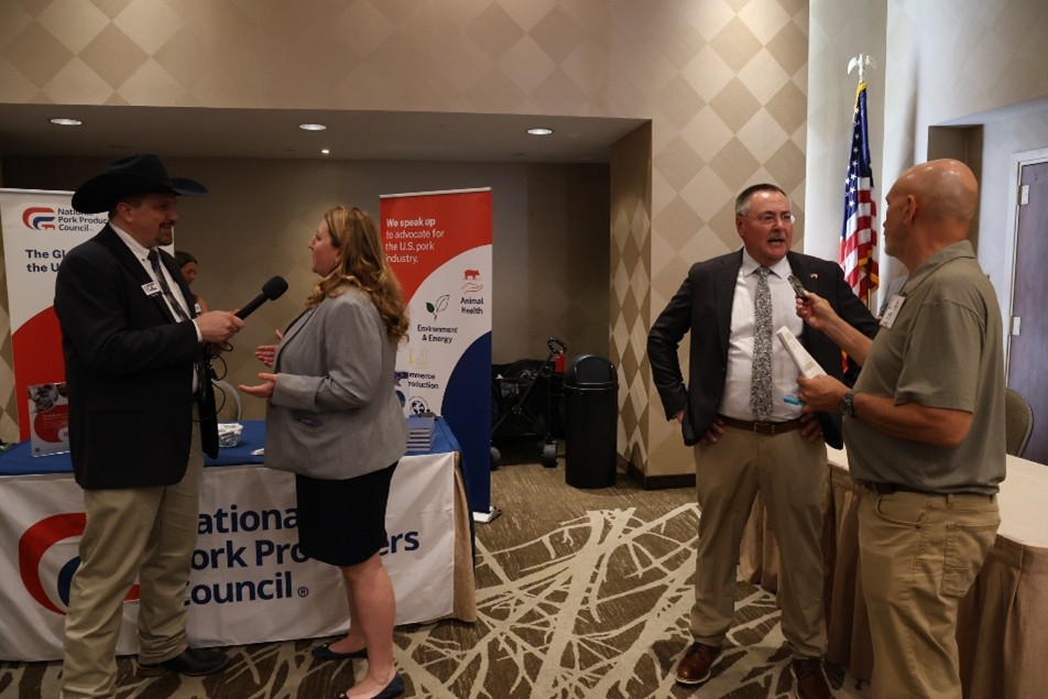 NPPC Vice President Todd Marotz (second from right) is interviewed by NAFB’s Mike Davis while NPPC Director of Food Policy Dr. Ashley Johnson (second from left) is interviewed by Northern Ag Network’s Andy Schwab.